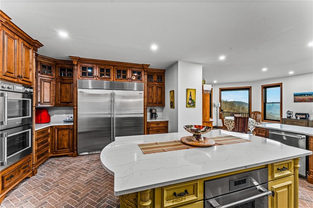 365 South Penn Road Franklin, PA 16323 - Photo 35 of 45 a kitchen with stainless steel appliances a dining table chairs and stove top oven