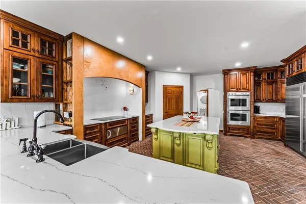 a kitchen with sink refrigerator and stove