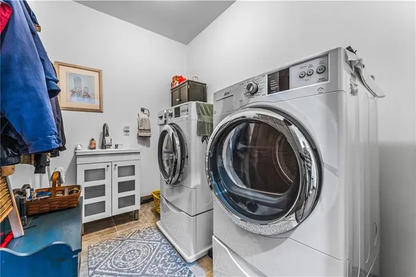 a spacious bedroom with a bed and a flat screen tv