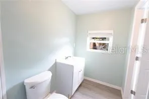 a white toilet sitting next to a bathroom sink