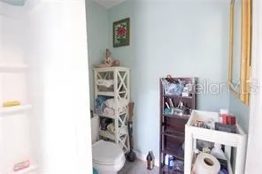a bathroom with a toilet and a shower curtain