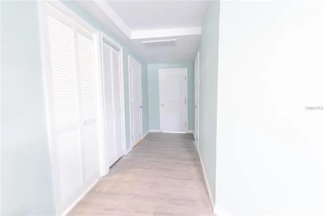 a view of a hallway with a white walls