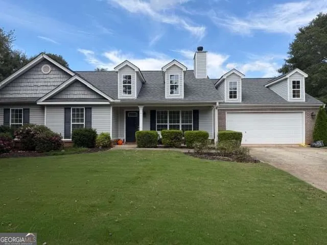 a front view of a house with a garden and plants