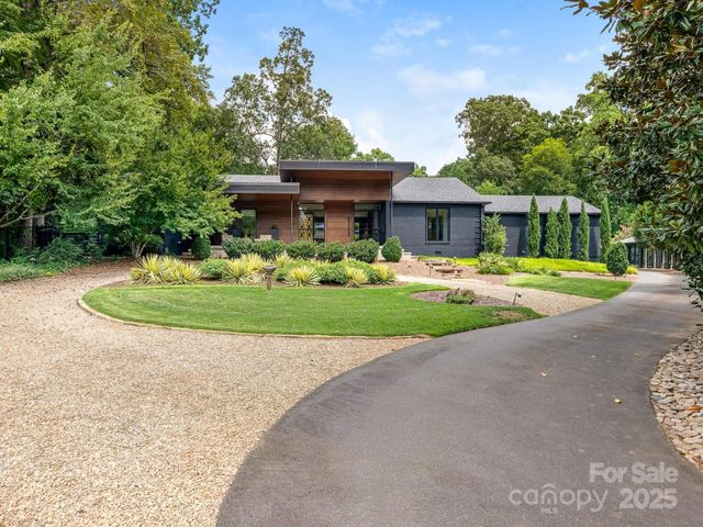 a front view of a house with a yard and trees