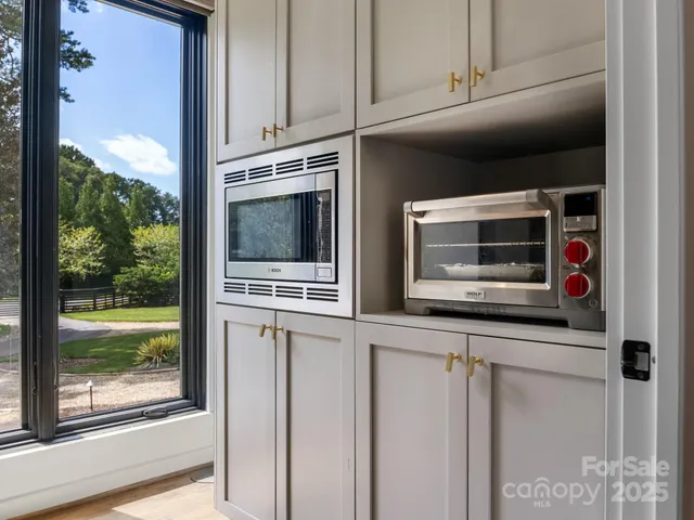 a kitchen with stainless steel appliances and cabinets