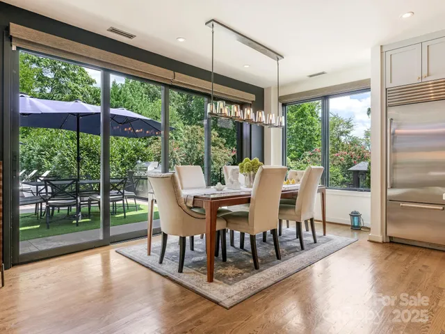 a dining space with furniture window and wooden floor