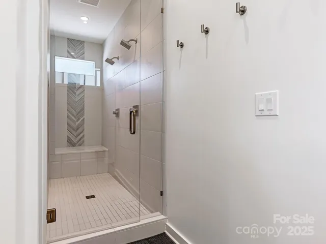 a bathroom with a glass shower door