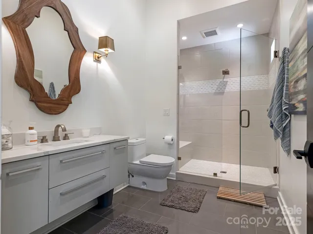 a bathroom with a toilet sink and shower