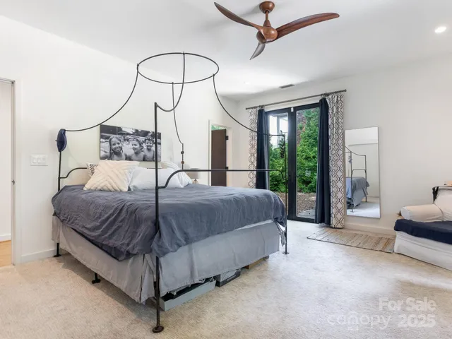 a spacious bedroom with a bed couch and a window