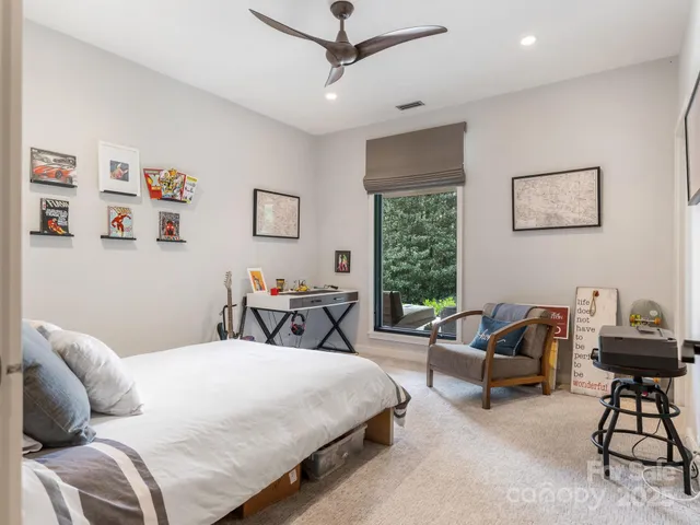 a bedroom with a bed a couch and a window