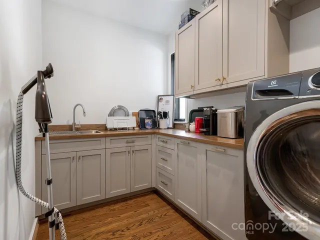 a kitchen with sink cabinets and a stove top oven
