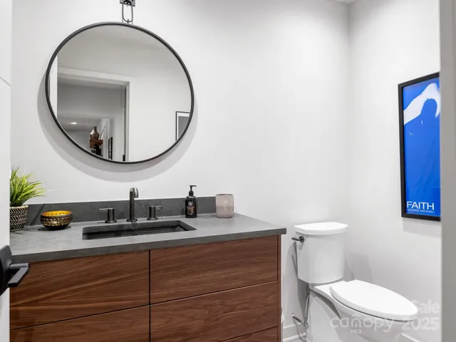 a bathroom with a toilet a sink and a mirror
