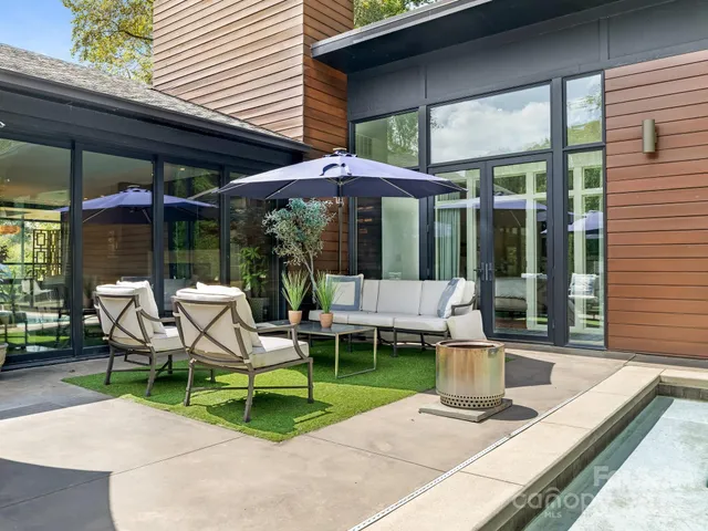 a view of a house with backyard porch and sitting area