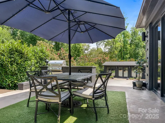 a patio with a patio table and chairs