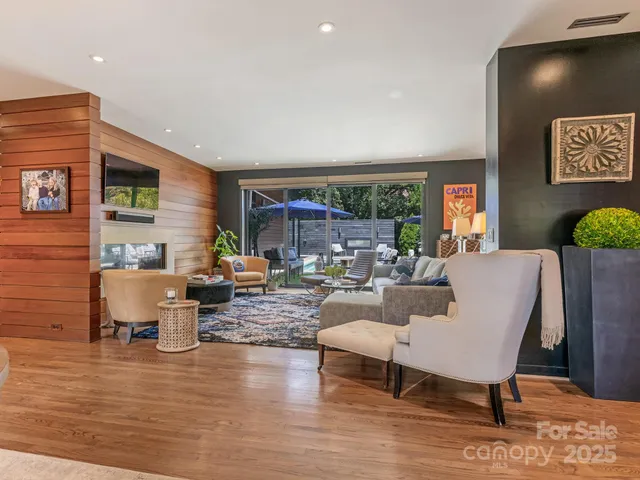 a living room with fireplace furniture and a wooden floor