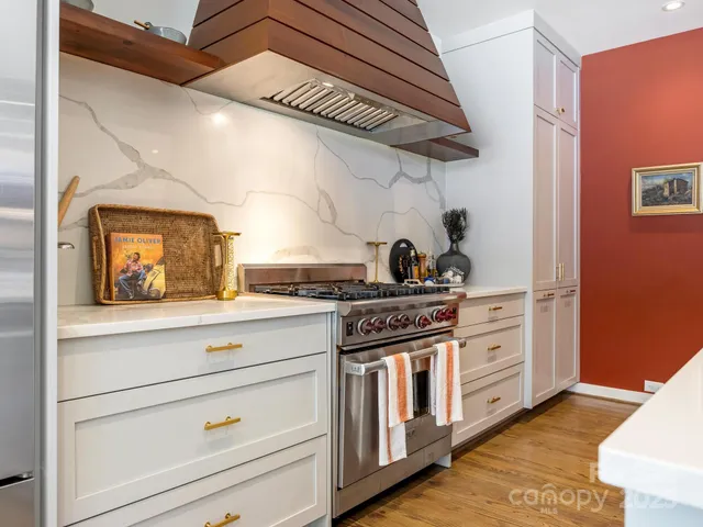 a kitchen with stainless steel appliances granite countertop a stove and a refrigerator