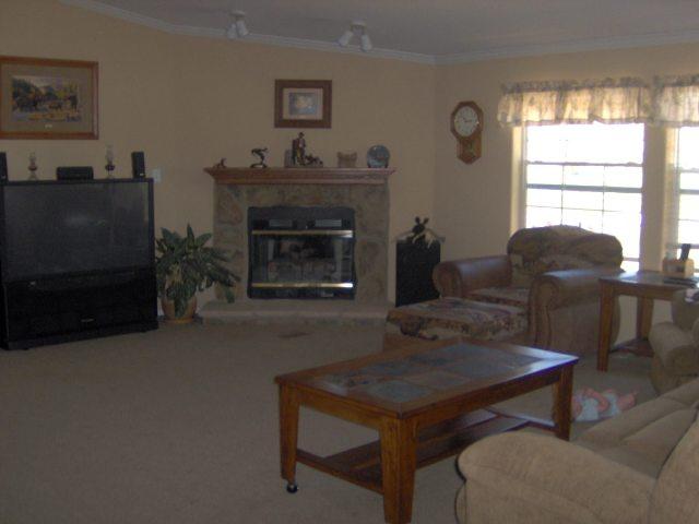 2899 County Road 233, Unit 233 Rifle, CO 81650 - Photo 2 of 6 a living room with furniture a window and a fireplace