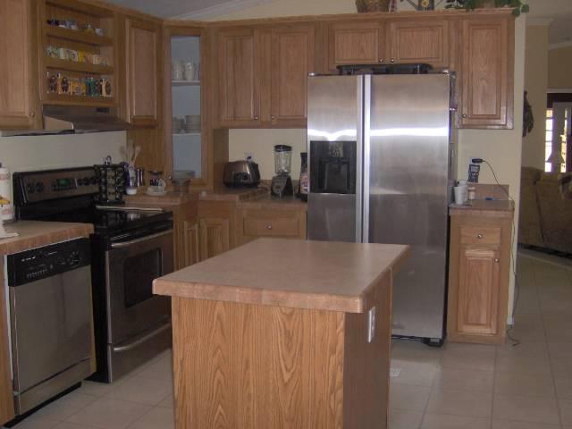 2899 County Road 233, Unit 233 Rifle, CO 81650 - Photo 3 of 6 a kitchen with kitchen island a counter top space cabinets and stainless steel appliances