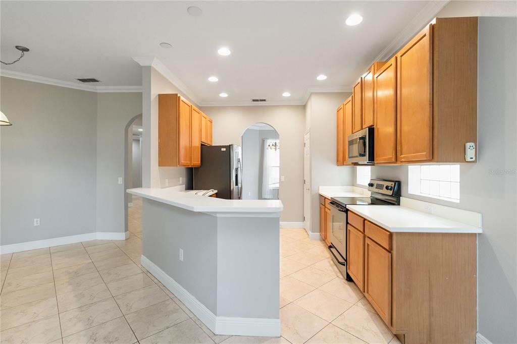 11322 Rapallo Lane Windermere, FL 34786 - Photo 12 of 39 a kitchen with stainless steel appliances a sink stove and cabinets