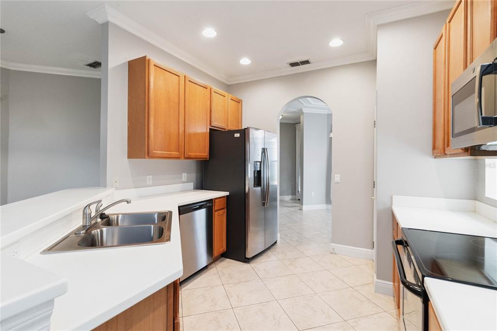 11322 Rapallo Lane Windermere, FL 34786 - Photo 13 of 39 a kitchen with stainless steel appliances granite countertop a refrigerator a sink a stove and island