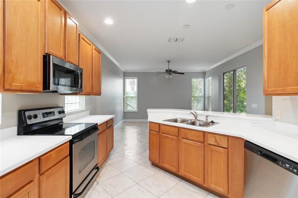 11322 Rapallo Lane Windermere, FL 34786 - Photo 15 of 39 a kitchen with a sink stove and microwave