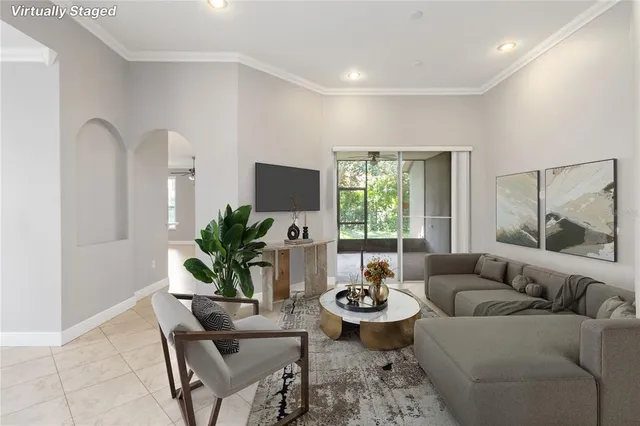 a living room with furniture and a potted plant