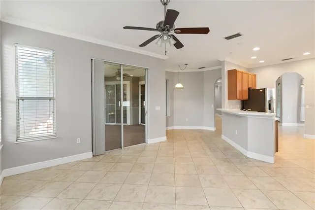 a view of kitchen with stainless steel appliances cabinets and large window