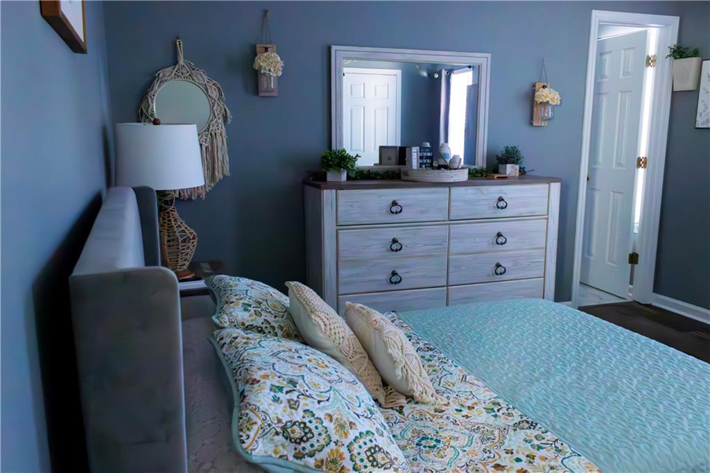 50 Berkeley Place Cartersville, GA 30121 - Photo 37 of 54 a bed room with a bed mirror and a lamp