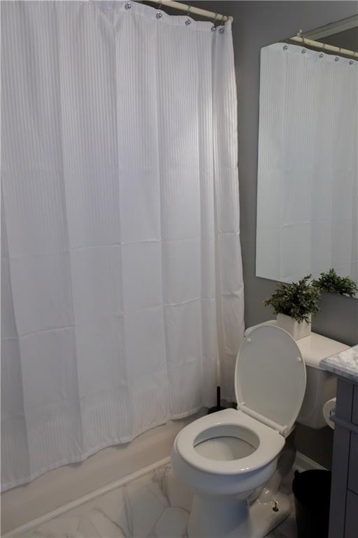 50 Berkeley Place Cartersville, GA 30121 - Photo 42 of 54 a white toilet sitting next to a shower curtain