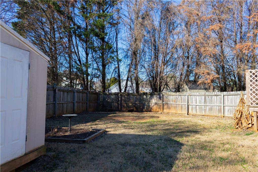 50 Berkeley Place Cartersville, GA 30121 - Photo 53 of 54 a view of a yard with wooden fence and trees