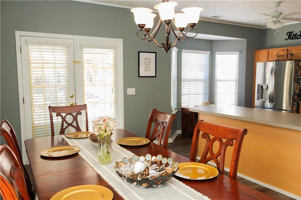 50 Berkeley Place Cartersville, GA 30121 - Photo 10 of 54 a dining room with furniture a rug a potted plant and a chandelier