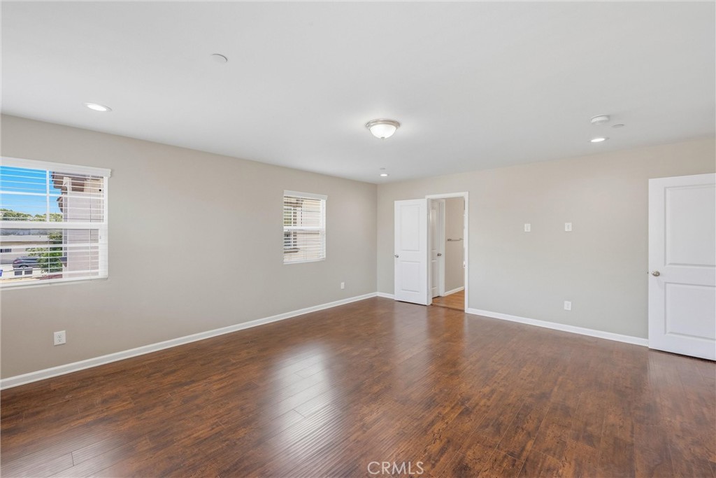 956 West Tibbot Street Rialto, CA 92377 - Photo 25 of 37 an empty room with wooden floor and windows