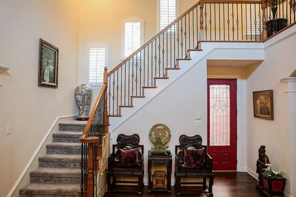 a view of entryway and hall with wooden floor