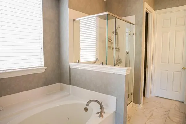 a bathroom with a tub sink and a window