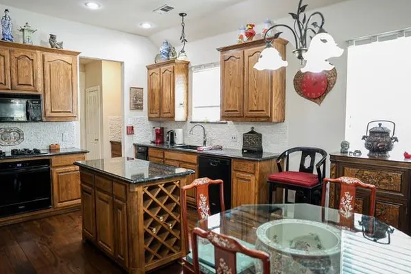 a kitchen with stainless steel appliances granite countertop a refrigerator stove and sink