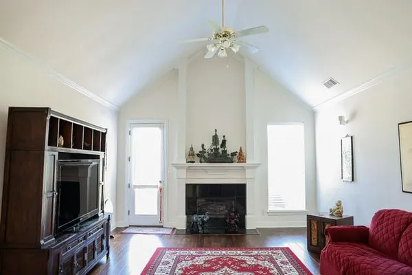 a kitchen with stainless steel appliances a sink a stove a dining table and chairs