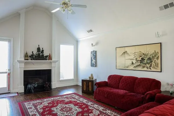 a living room with furniture a fireplace and a flat screen tv
