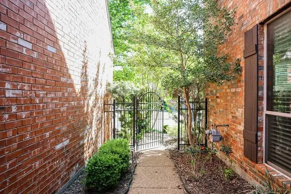 a pathway of a house with a trees