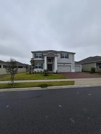 a view of house with a big yard