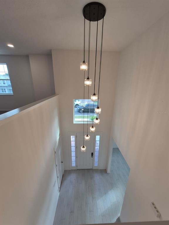 5197 Prairie Preserve Run St. Cloud, FL 34772 - Photo 4 of 39 a view of a hallway with a chandelier