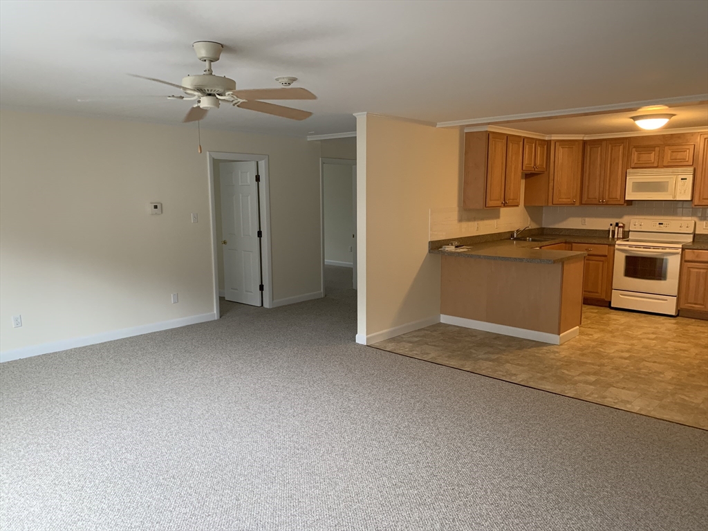23 Elm Street, Unit 1 Manchester, MA 01944 - Photo 3 of 8 a view of a kitchen with a sink and dishwasher a stove top oven