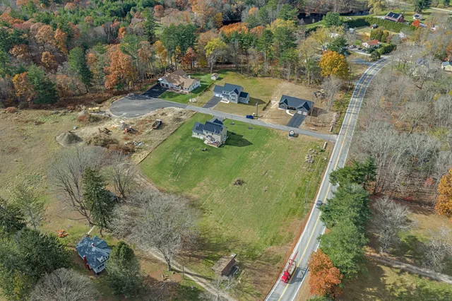 an aerial view of a residential houses with outdoor space