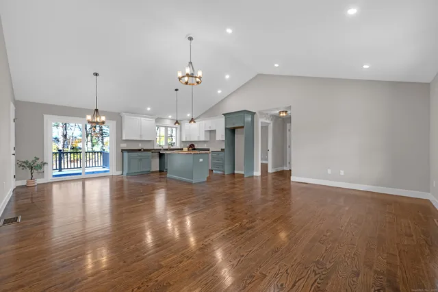 a view of a room with a window and wooden floor