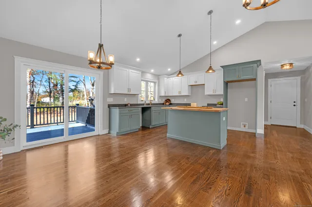 a kitchen with stainless steel appliances granite countertop a sink a stove and a refrigerator