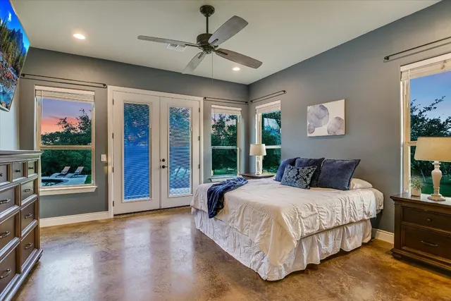 a bedroom with a large bed and a chandelier