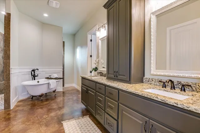 a spacious bathroom with a double vanity sink and a mirror