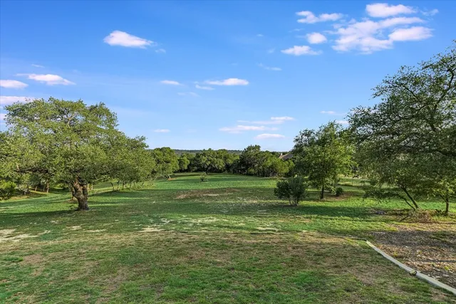 a view of outdoor space with green field and trees
