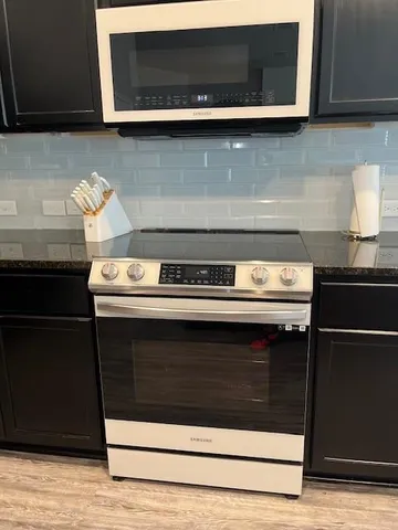 a stove top oven sitting inside of a kitchen