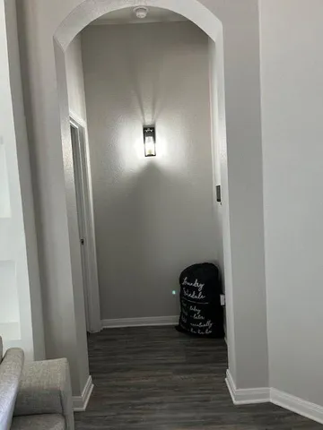 a view of a livingroom with wooden floor and a window