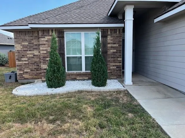 a front view of a house with garden